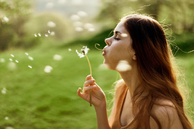 Young woman blowing bubbles