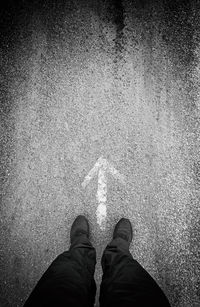 Low section of man standing on street