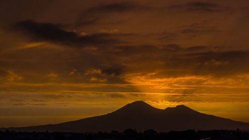 Scenic view of mountains against sky at sunset