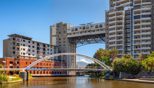 View of bridge over canal against buildings