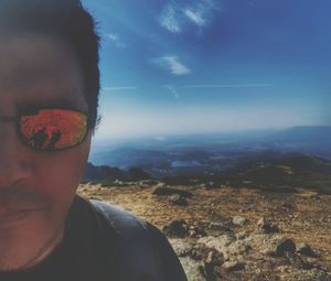Portrait of young man against mountains