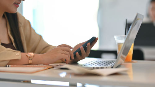 Midsection of woman working at office