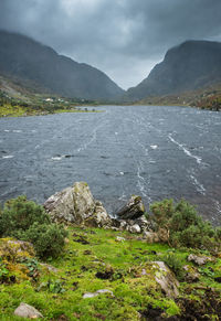 Scenic view of lake and mountains against sky