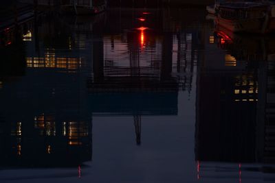 Reflection of illuminated building in water at night