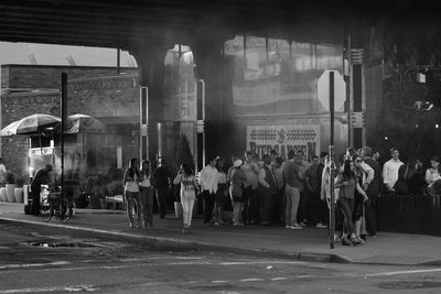 People waiting on street in city