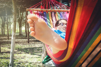 Woman relaxing in hammock outdoors