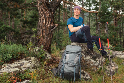 Rear view of man standing in forest