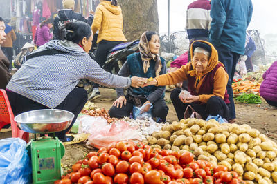 Group of people at market stall