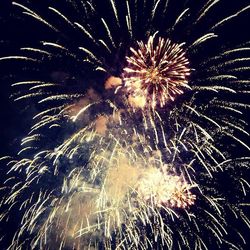 Low angle view of firework display at night