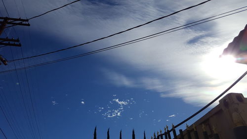 Low angle view of cables against blue sky