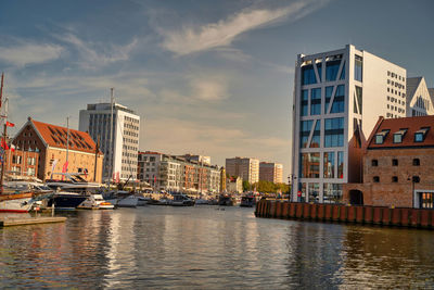 River by buildings against sky in gdansk city of north poland 