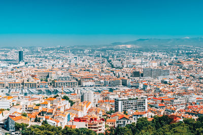 High angle view of townscape against blue sky