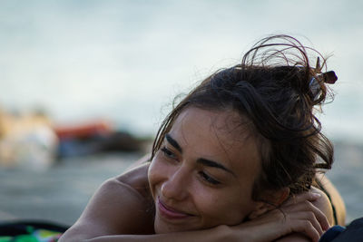 Close-up of smiling woman at beach