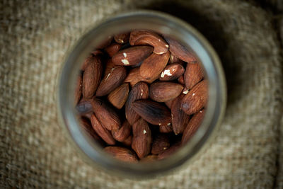 High angle view of roasted almonds in glass