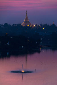 View of illuminated temple against sky at sunset