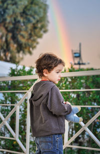 Boy standing on railing