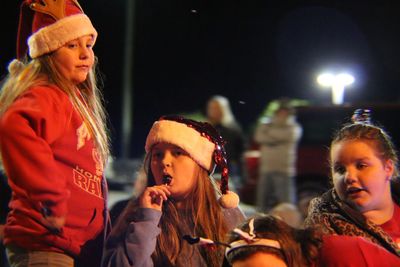 Young woman enjoying music concert at night