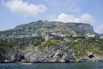 Scenic view of sea and mountains against sky