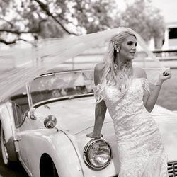 Young woman standing in car