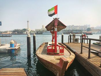 Pier over river against sky in city