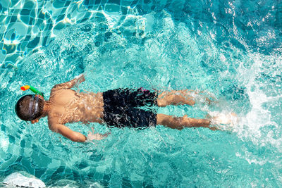 Directly above shot of boy swimming in pool