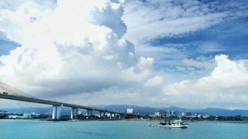 View of harbor against cloudy sky