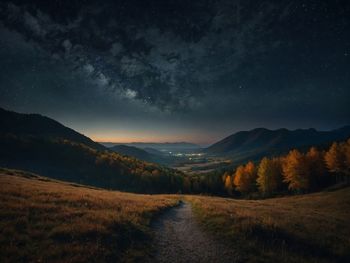 Scenic view of landscape against sky at night