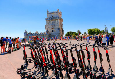 Electric scooters in lisbon on the banks of the tago river and in the background the belém tower