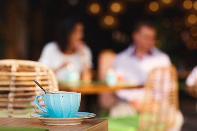 Morning coffee on the cozy cafe terrace. a cup of coffee is on a table in an outdoor cafe, close-up