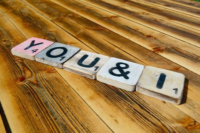 High angle view of text blocks on wooden table