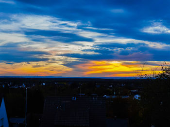 Silhouette cityscape against sky during sunset