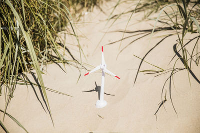 Model wind turbine on the beach in dunes