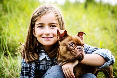 Portrait of a smiling young woman with dog