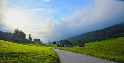 Country road passing through field