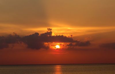 Scenic view of sea against romantic sky at sunset