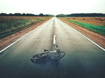 Bicycle on road against sky