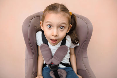 Portrait of young woman sitting on sofa at home