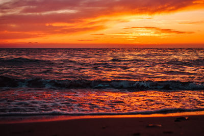 Scenic view of sea against romantic sky at sunset