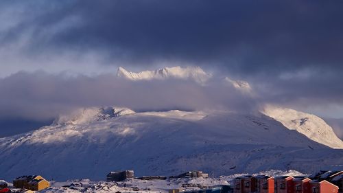 Scenic view of snow covered mountains against sky