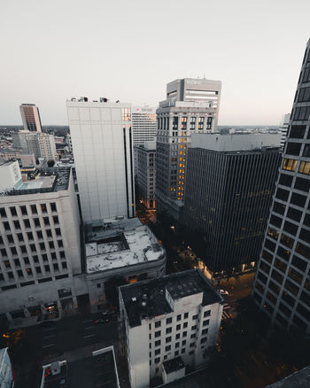 HIGH ANGLE VIEW OF MODERN BUILDINGS AGAINST CLEAR SKY