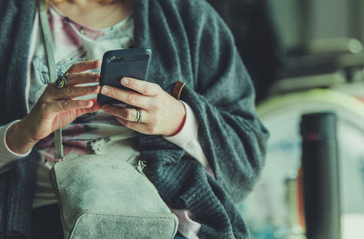 Midsection of man using mobile phone