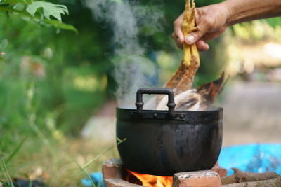 Midsection of person preparing food outdoors