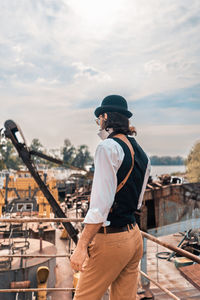 Full length of man standing against sky in city