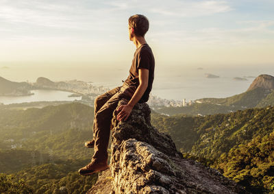 Full length of man looking at view of mountains