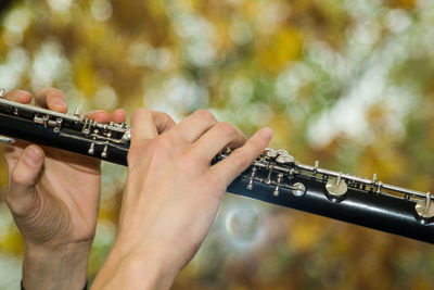 Cropped image of person playing clarinet