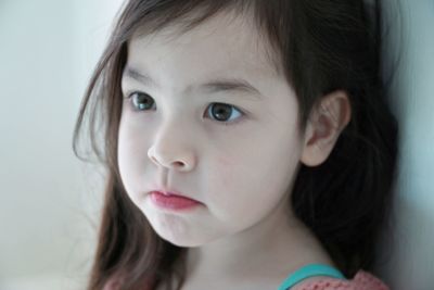 Close-up portrait of cute girl looking away