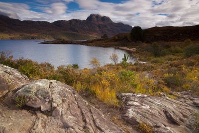 Scenic view of lake and mountains against sky