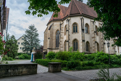 View of trees and building against sky