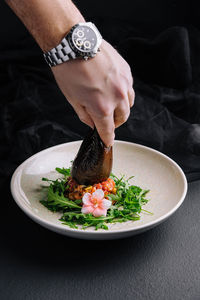 Midsection of man holding food in plate