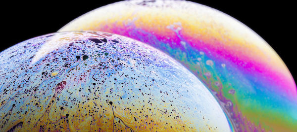 Close-up of bubbles over black background